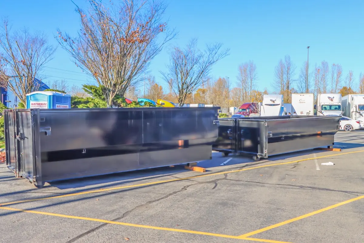 Professional dumpster rental service with roll-off container on residential driveway in Oak Ridge